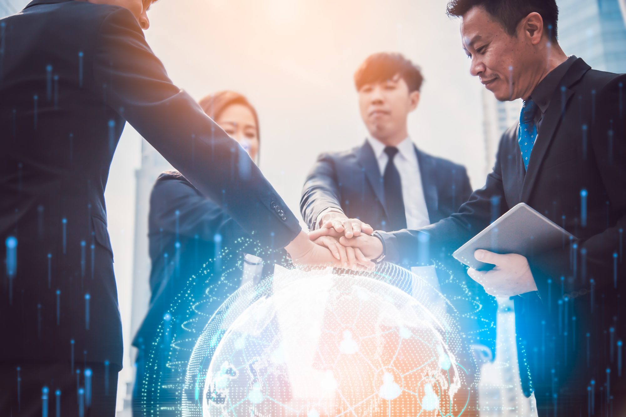 Close up of businessmen shaking hands. Global network and a worl